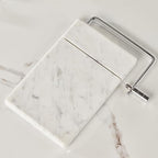 White Marble Cheese Board with Stainless Steel Slicer - Unique Grey Veining and Grooved Design White Marble Cheese Board, Cheese Cutting Serveware For Kitchen, 9.75" W x 8.5" D x 0.75" H
